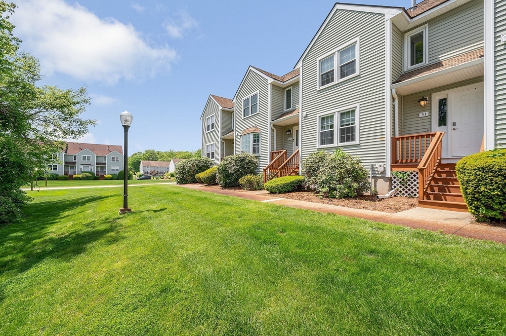 31 Patrick Road, Unit 31 Tewksbury, MA 01876 - Photo 2 of 40 a house view with a garden space