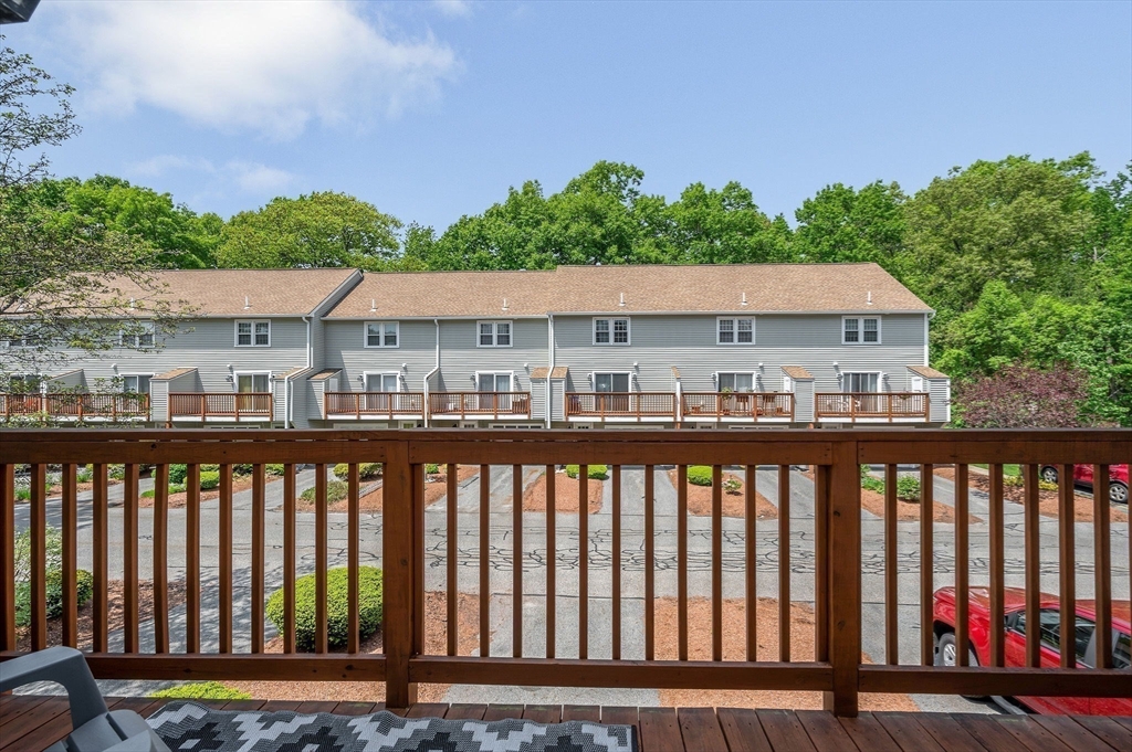 31 Patrick Road, Unit 31 Tewksbury, MA 01876 - Photo 21 of 40 a view of a balcony with wooden floor and fence