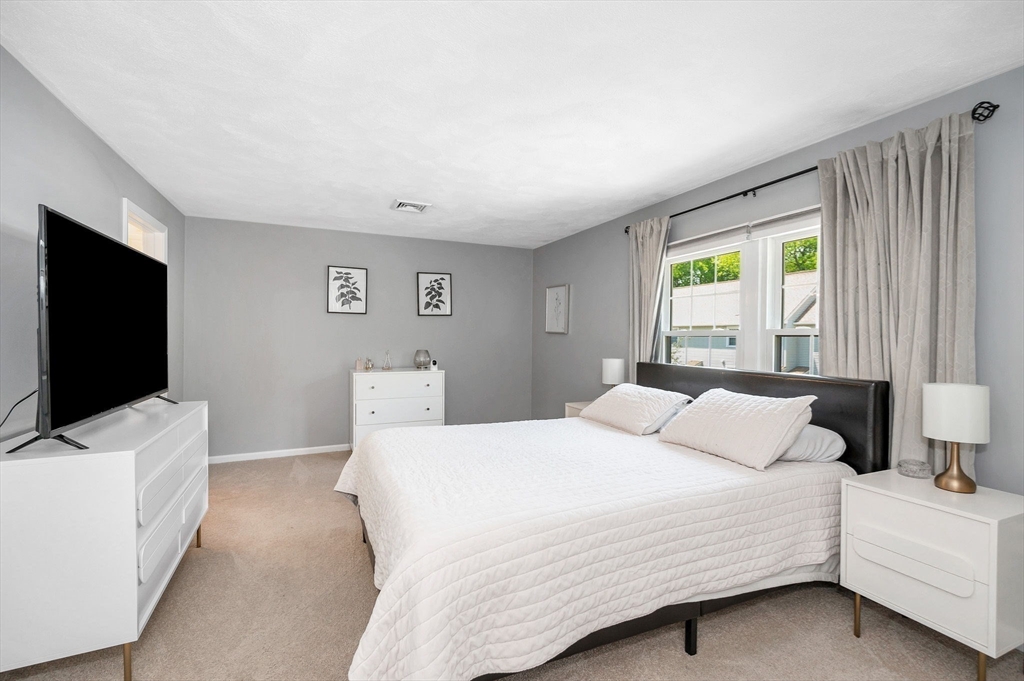 31 Patrick Road, Unit 31 Tewksbury, MA 01876 - Photo 26 of 40 a bedroom with a bed and a flat screen tv