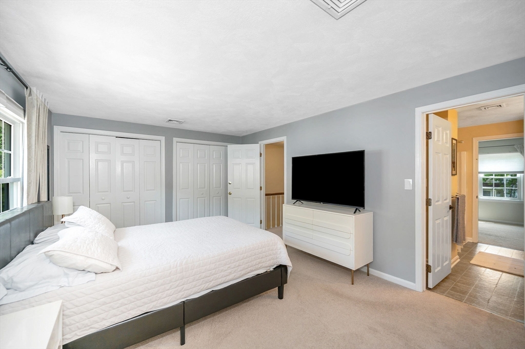 31 Patrick Road, Unit 31 Tewksbury, MA 01876 - Photo 27 of 40 a bedroom with a bed and a flat screen tv