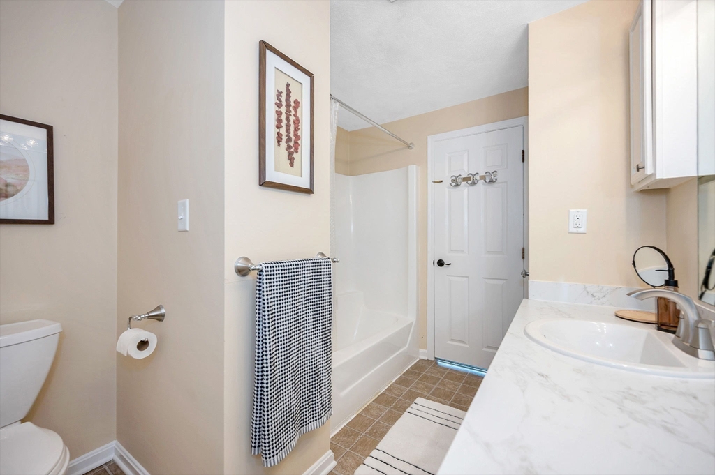 31 Patrick Road, Unit 31 Tewksbury, MA 01876 - Photo 28 of 40 a bathroom with a granite countertop sink a toilet and shower