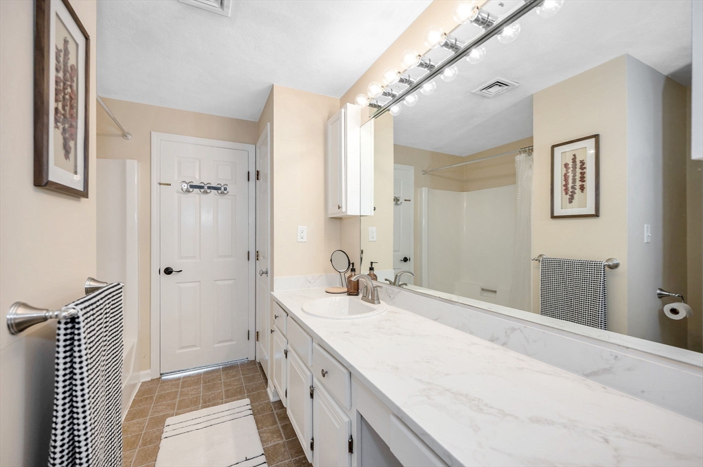 31 Patrick Road, Unit 31 Tewksbury, MA 01876 - Photo 29 of 40 a bathroom with a double vanity sink mirror and shower