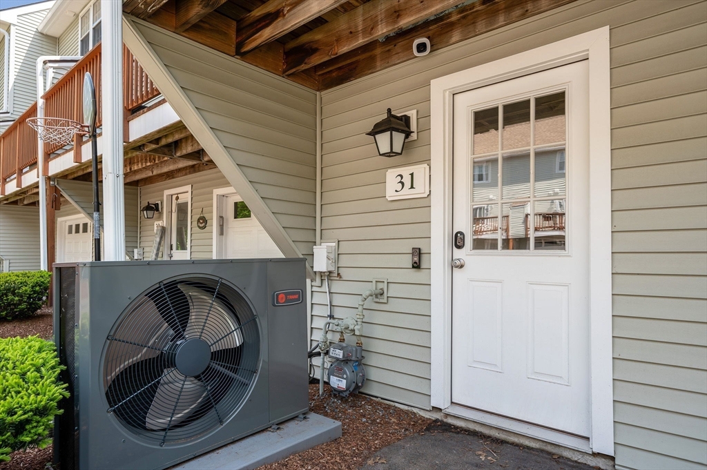 31 Patrick Road, Unit 31 Tewksbury, MA 01876 - Photo 3 of 40 a front view of a house with entryway