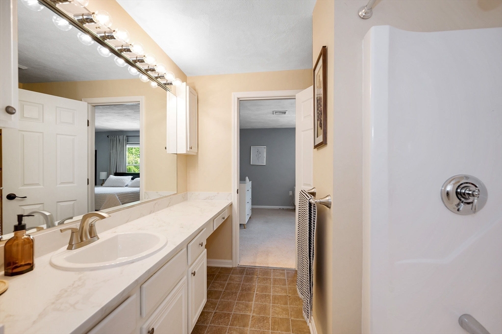 31 Patrick Road, Unit 31 Tewksbury, MA 01876 - Photo 31 of 40 a bathroom with a double vanity sink mirror and