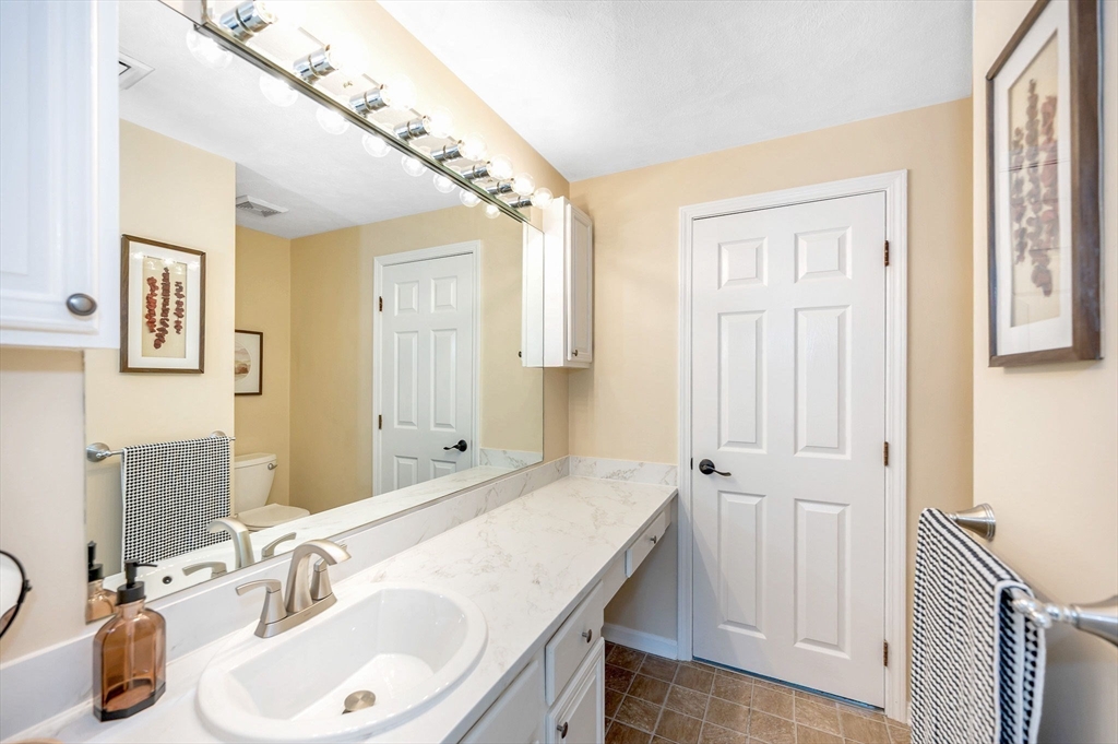 31 Patrick Road, Unit 31 Tewksbury, MA 01876 - Photo 32 of 40 a bathroom with a sink and a mirror