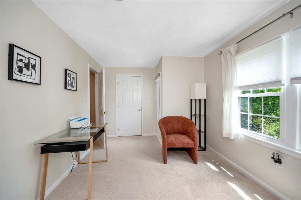 31 Patrick Road, Unit 31 Tewksbury, MA 01876 - Photo 35 of 40 a living room with furniture and a window