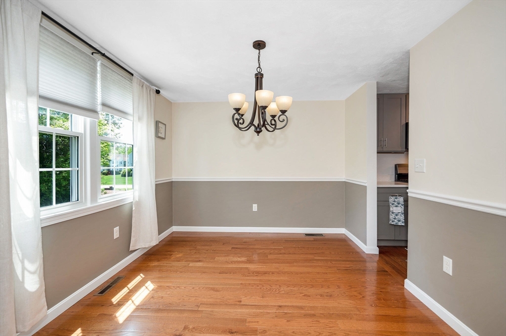 31 Patrick Road, Unit 31 Tewksbury, MA 01876 - Photo 6 of 40 a view of an empty room with wooden floor and a window