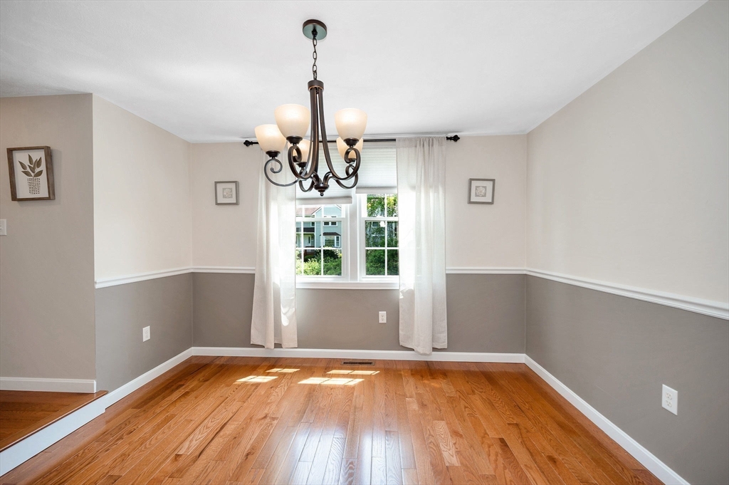 31 Patrick Road, Unit 31 Tewksbury, MA 01876 - Photo 7 of 40 a view of a room with window wooden floor and a chandelier