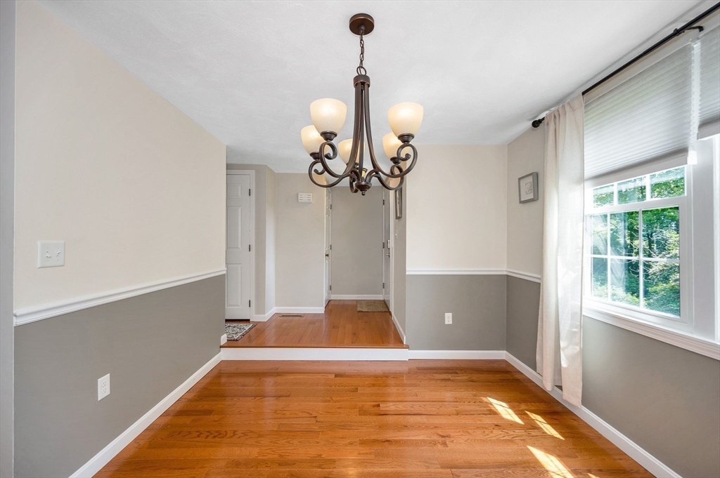 31 Patrick Road, Unit 31 Tewksbury, MA 01876 - Photo 8 of 40 a view of empty room with wooden floor and fan