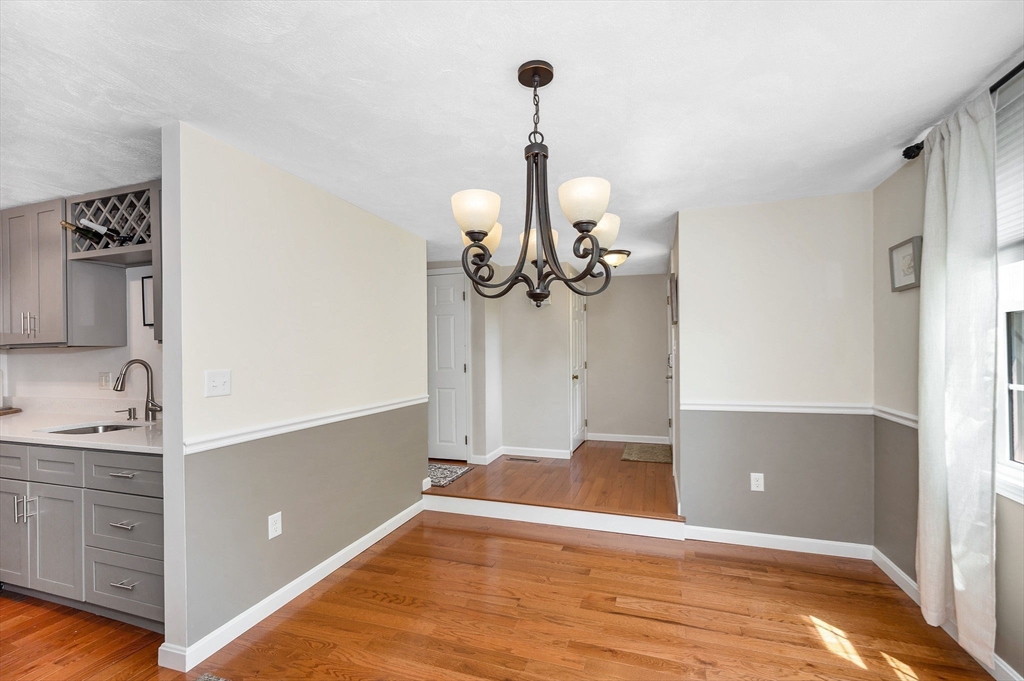 31 Patrick Road, Unit 31 Tewksbury, MA 01876 - Photo 9 of 40 a view of a room with wooden floor and cabinet