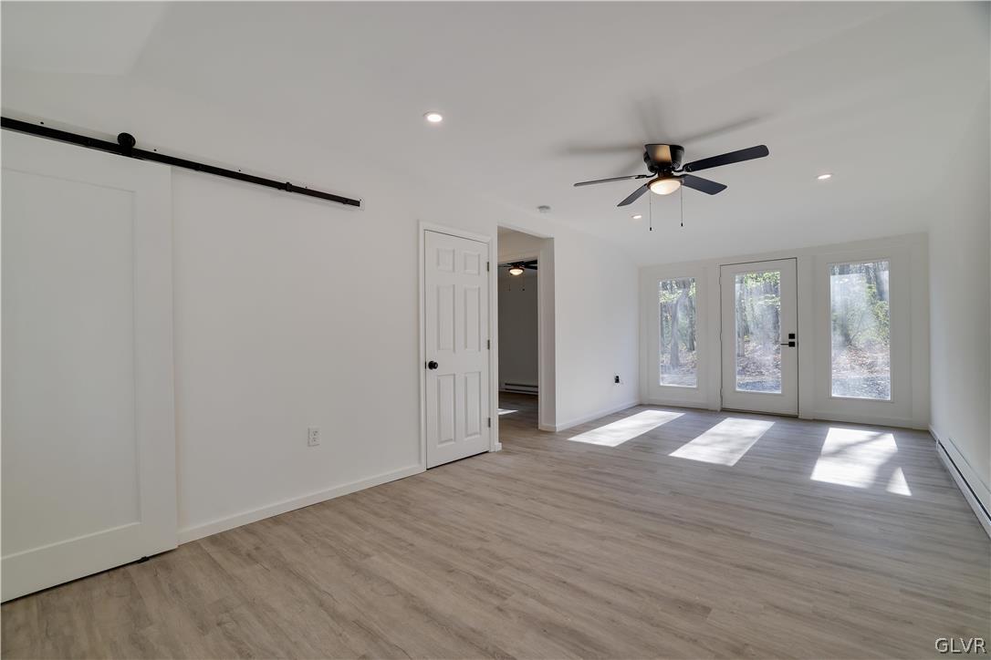 107 Barrys Road Effort, PA 18330 - Photo 3 of 32 a view of empty room with wooden floor and fan