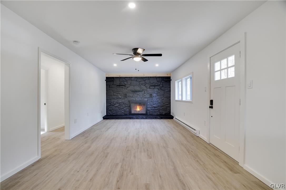 107 Barrys Road Effort, PA 18330 - Photo 5 of 32 wooden floor in an empty room with a fireplace