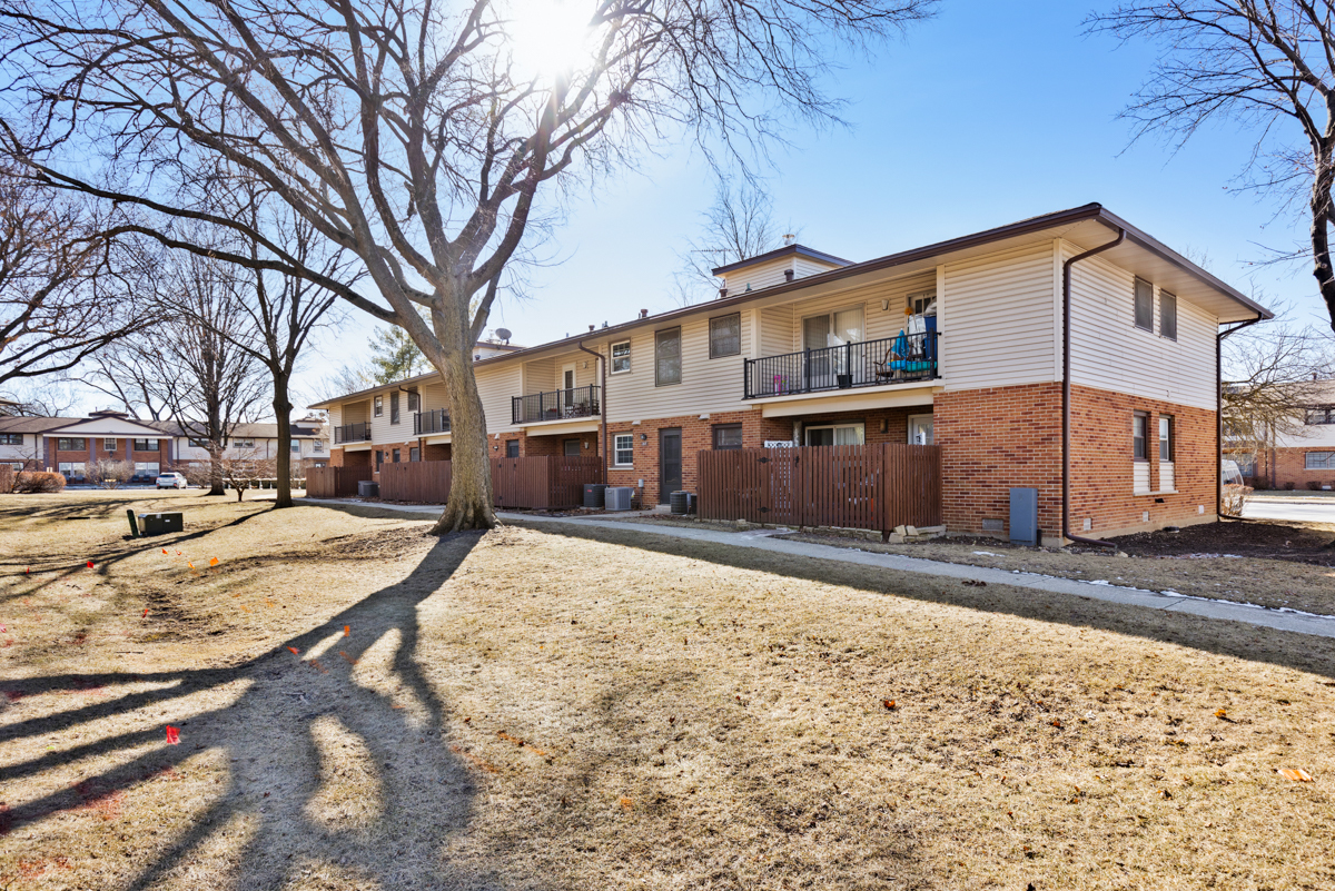 217 Washington Square, Unit D Elk Grove Village, IL 60007 - Photo 14 of 14 a view of a house with snow on the road