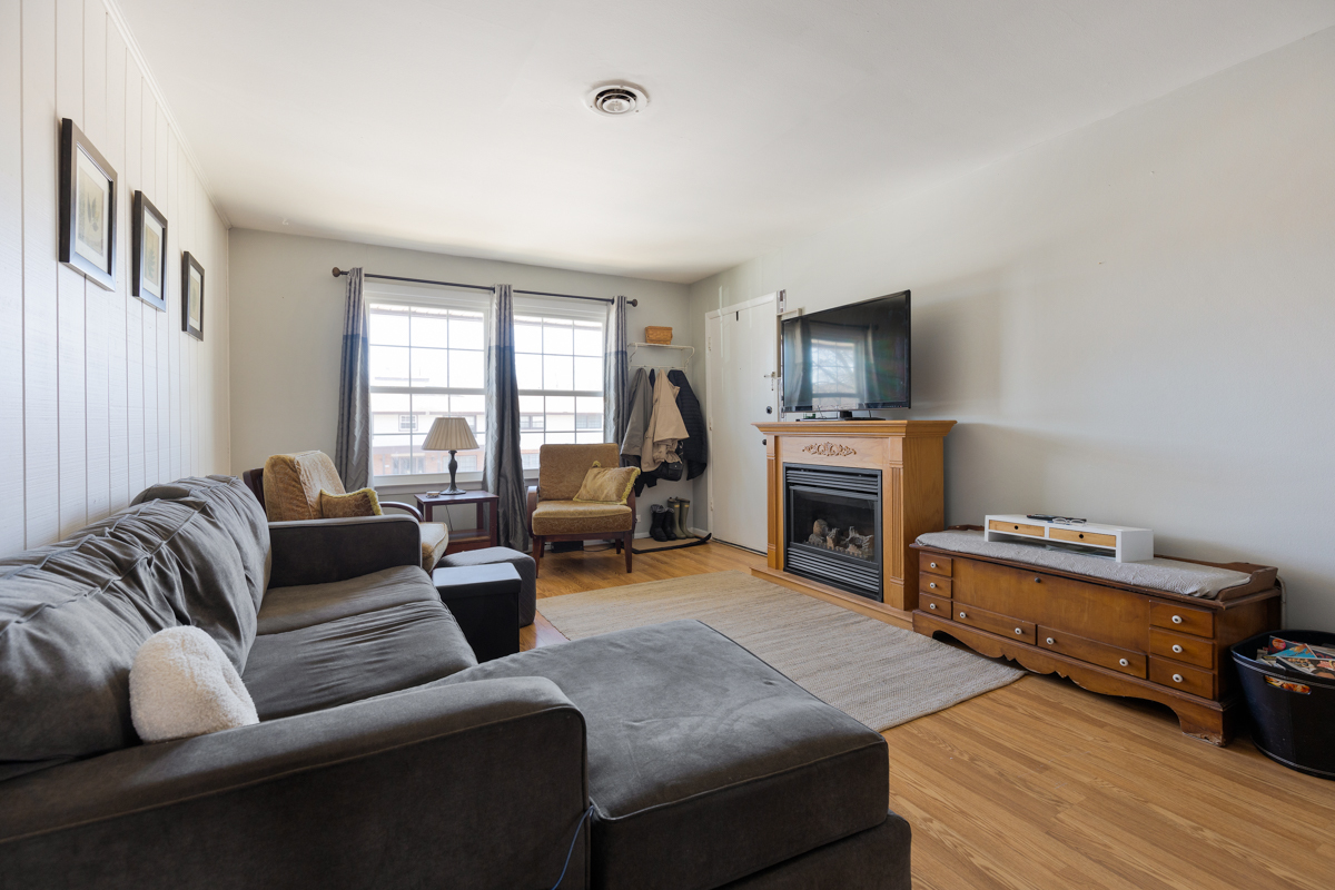 217 Washington Square, Unit D Elk Grove Village, IL 60007 - Photo 2 of 14 a living room with furniture and a fireplace