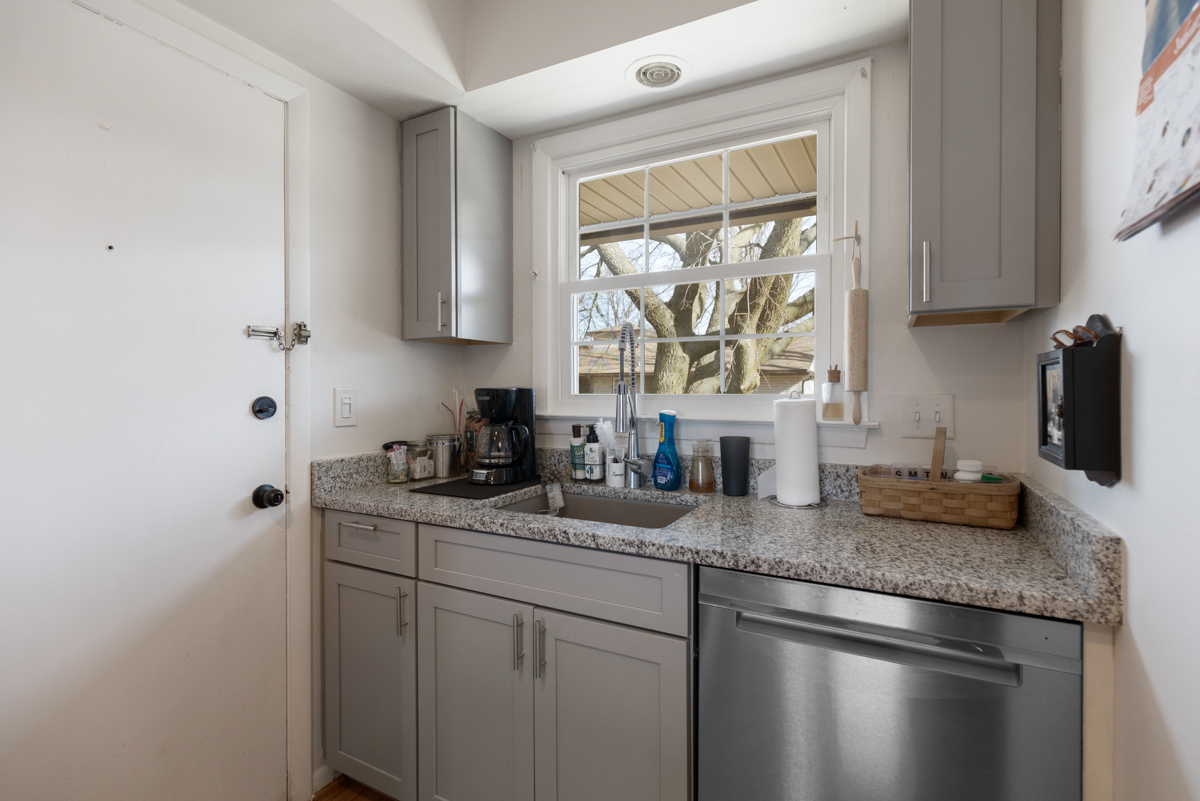 217 Washington Square, Unit D Elk Grove Village, IL 60007 - Photo 7 of 14 a kitchen with granite countertop stainless steel appliances a sink window and cabinets