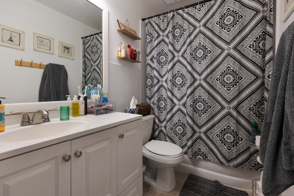 217 Washington Square, Unit D Elk Grove Village, IL 60007 - Photo 10 of 14 a bathroom with a toilet sink and mirror