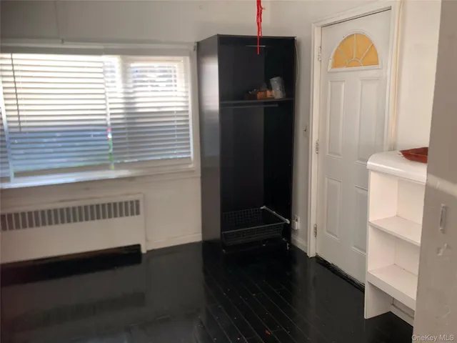 a view of hallway with wooden floor and stairs