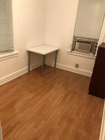 a view of a kitchen with furniture and wooden floor