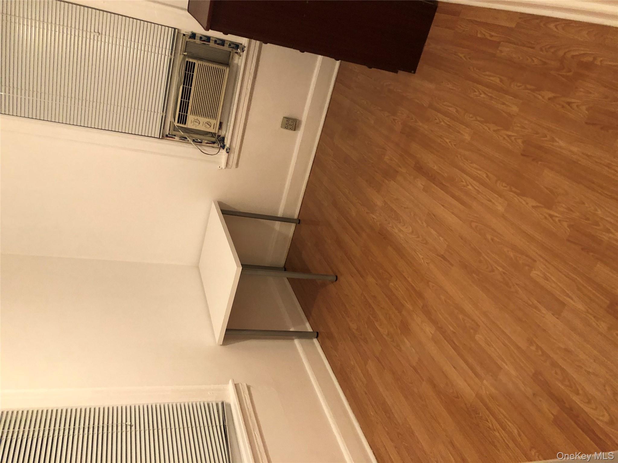 54-13 152nd Street Queens, NY 11355 - Photo 13 of 19 a view of a kitchen with furniture and wooden floor