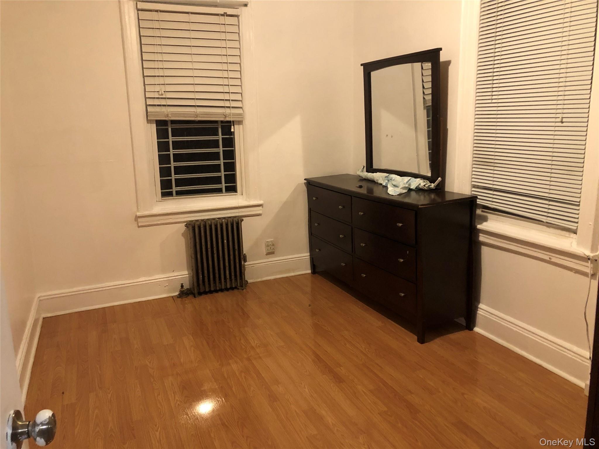 54-13 152nd Street Queens, NY 11355 - Photo 14 of 19 a room with a bed and a window