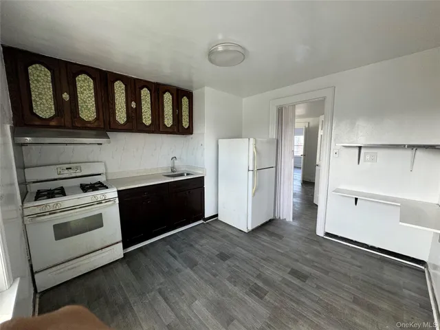 a kitchen with stainless steel appliances granite countertop a stove and a refrigerator