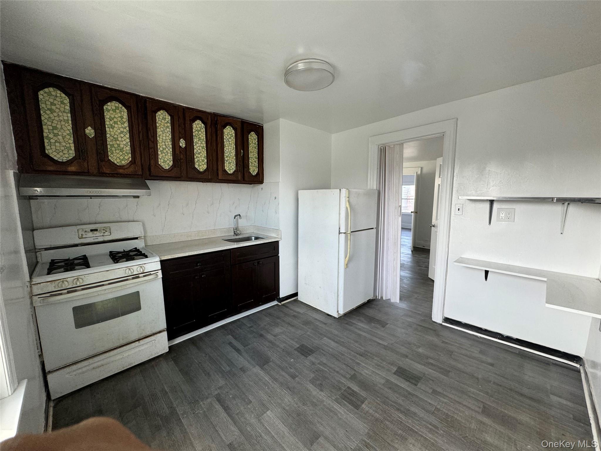 54-13 152nd Street Queens, NY 11355 - Photo 3 of 19 a kitchen with stainless steel appliances granite countertop a stove and a refrigerator
