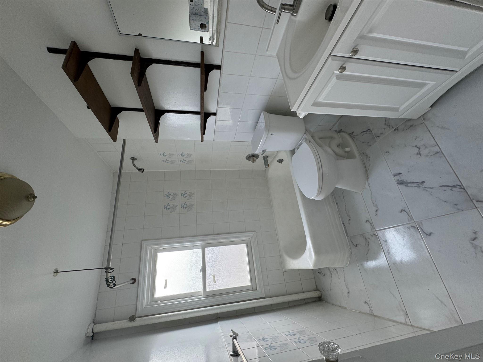 54-13 152nd Street Queens, NY 11355 - Photo 4 of 19 a bathroom with a toilet sink and mirror