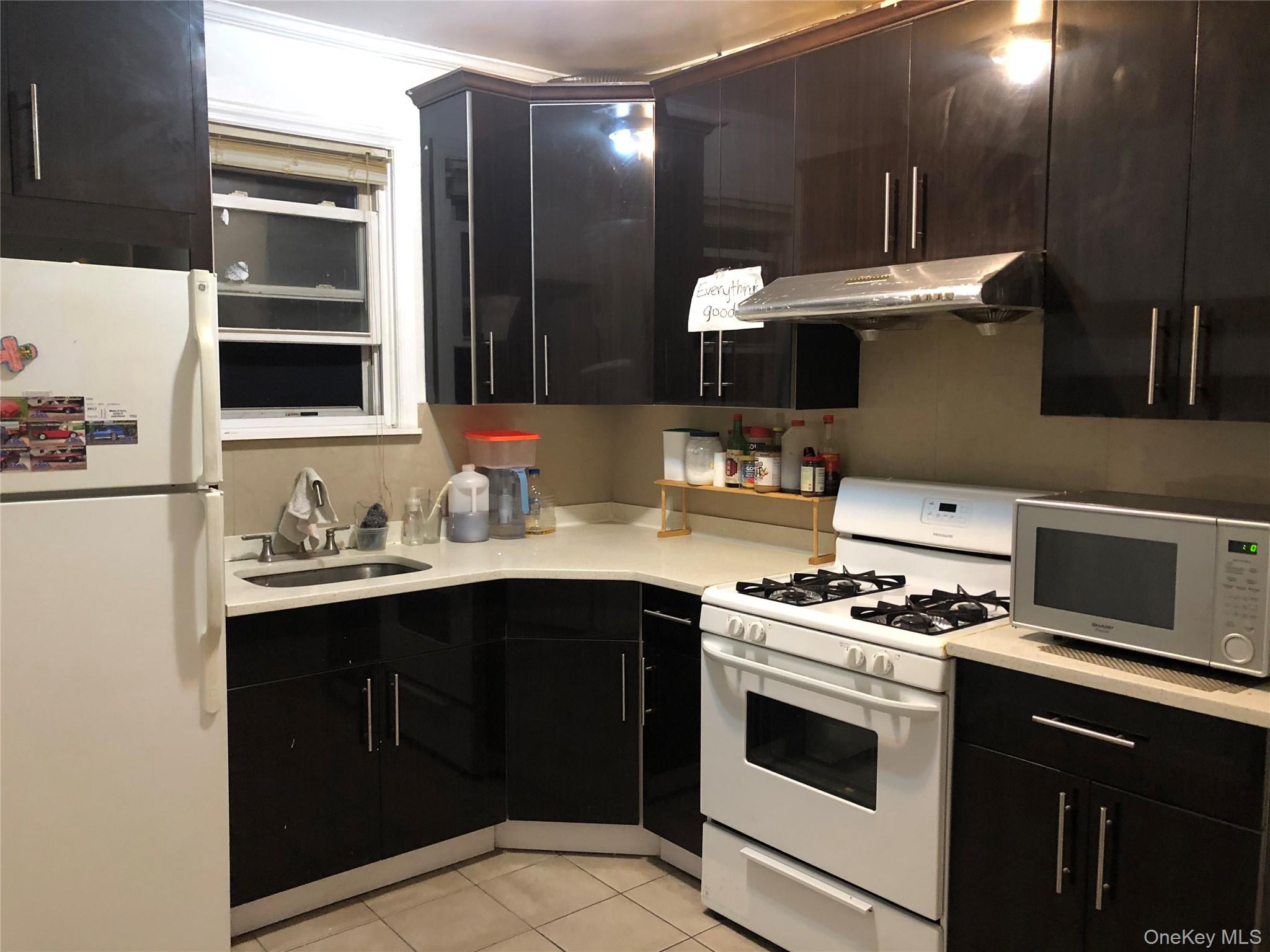 54-13 152nd Street Queens, NY 11355 - Photo 10 of 19 a kitchen with a sink and a stove
