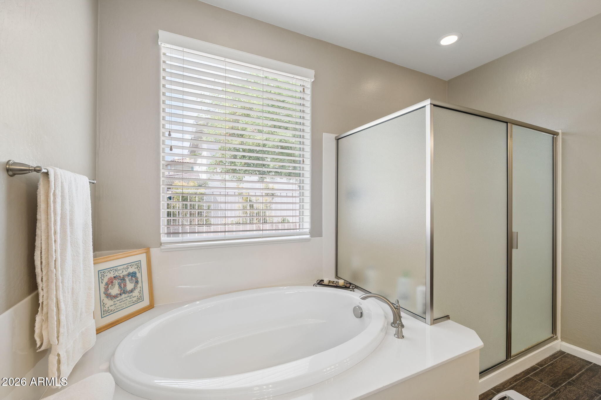 8993 West Ruth Avenue Peoria, AZ 85345 - Photo 12 of 24 a bathroom with a bathtub and a shower