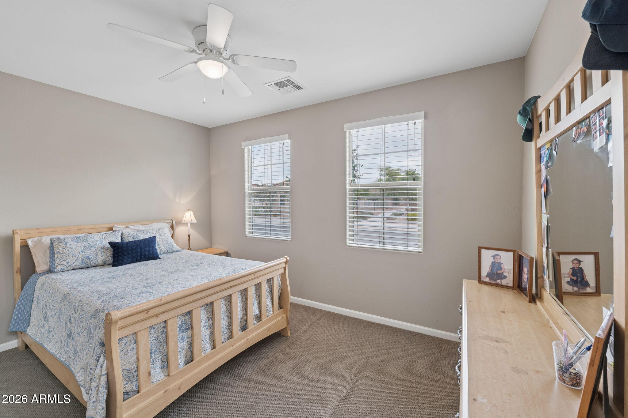 8993 West Ruth Avenue Peoria, AZ 85345 - Photo 13 of 24 a bedroom with a bed a flat screen tv and a window