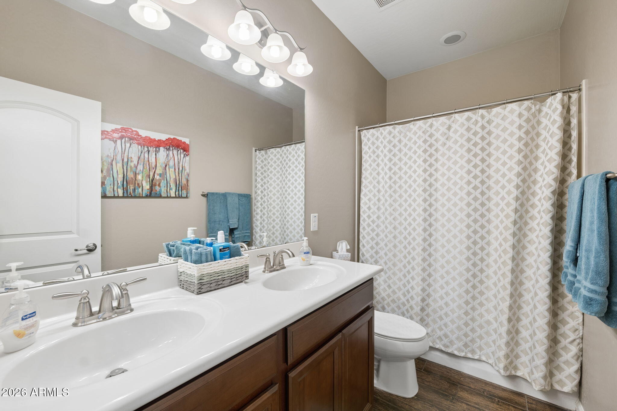 8993 West Ruth Avenue Peoria, AZ 85345 - Photo 15 of 24 a bathroom with a double vanity sink mirror and toilet