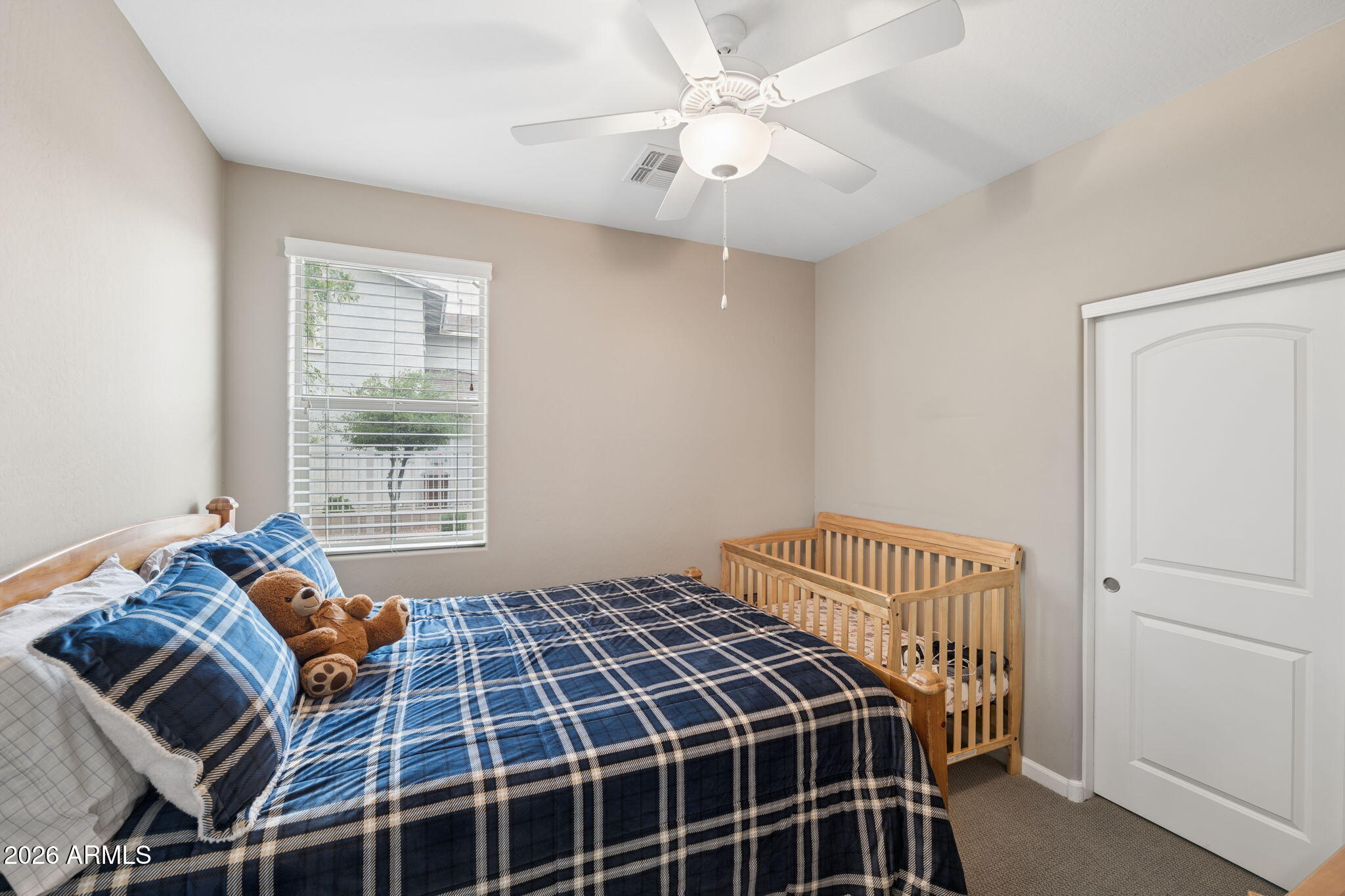 8993 West Ruth Avenue Peoria, AZ 85345 - Photo 16 of 24 a bedroom with a bed and a window