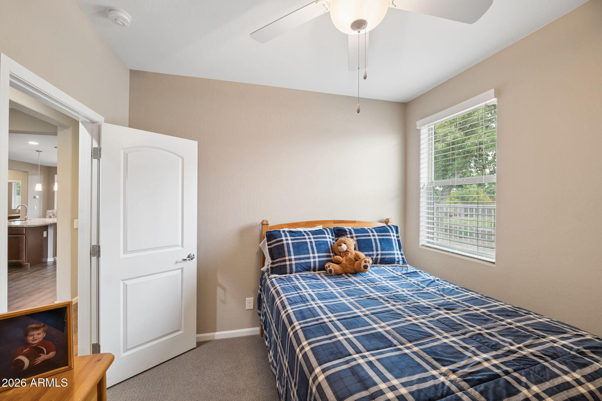 8993 West Ruth Avenue Peoria, AZ 85345 - Photo 17 of 24 a bedroom with a bed and wooden floor