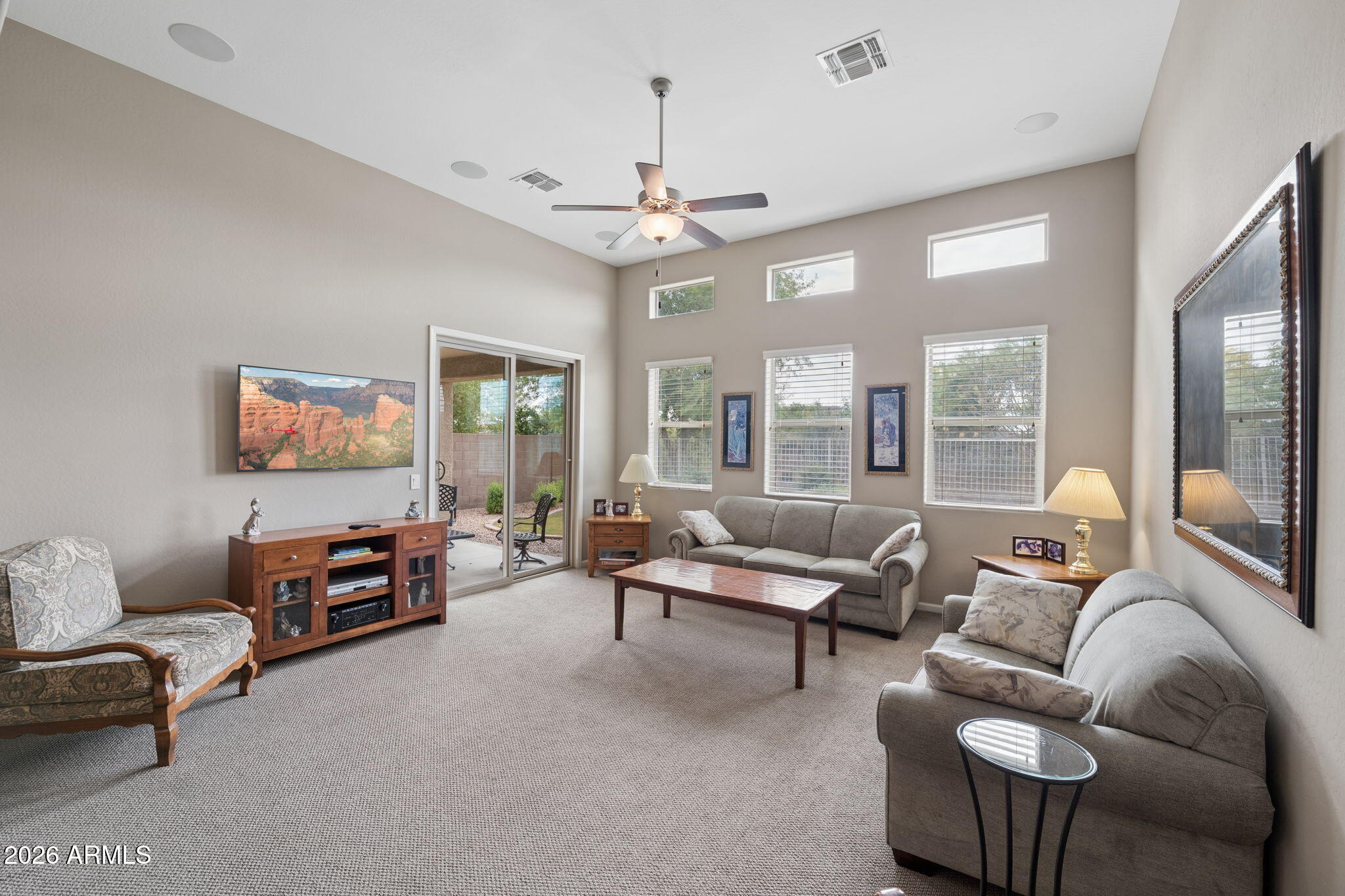 8993 West Ruth Avenue Peoria, AZ 85345 - Photo 6 of 24 a living room with furniture and a chandelier