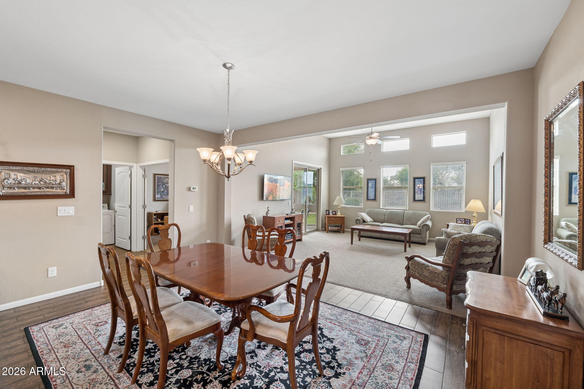 8993 West Ruth Avenue Peoria, AZ 85345 - Photo 8 of 24 a view of a dining room with furniture large windows and wooden floor