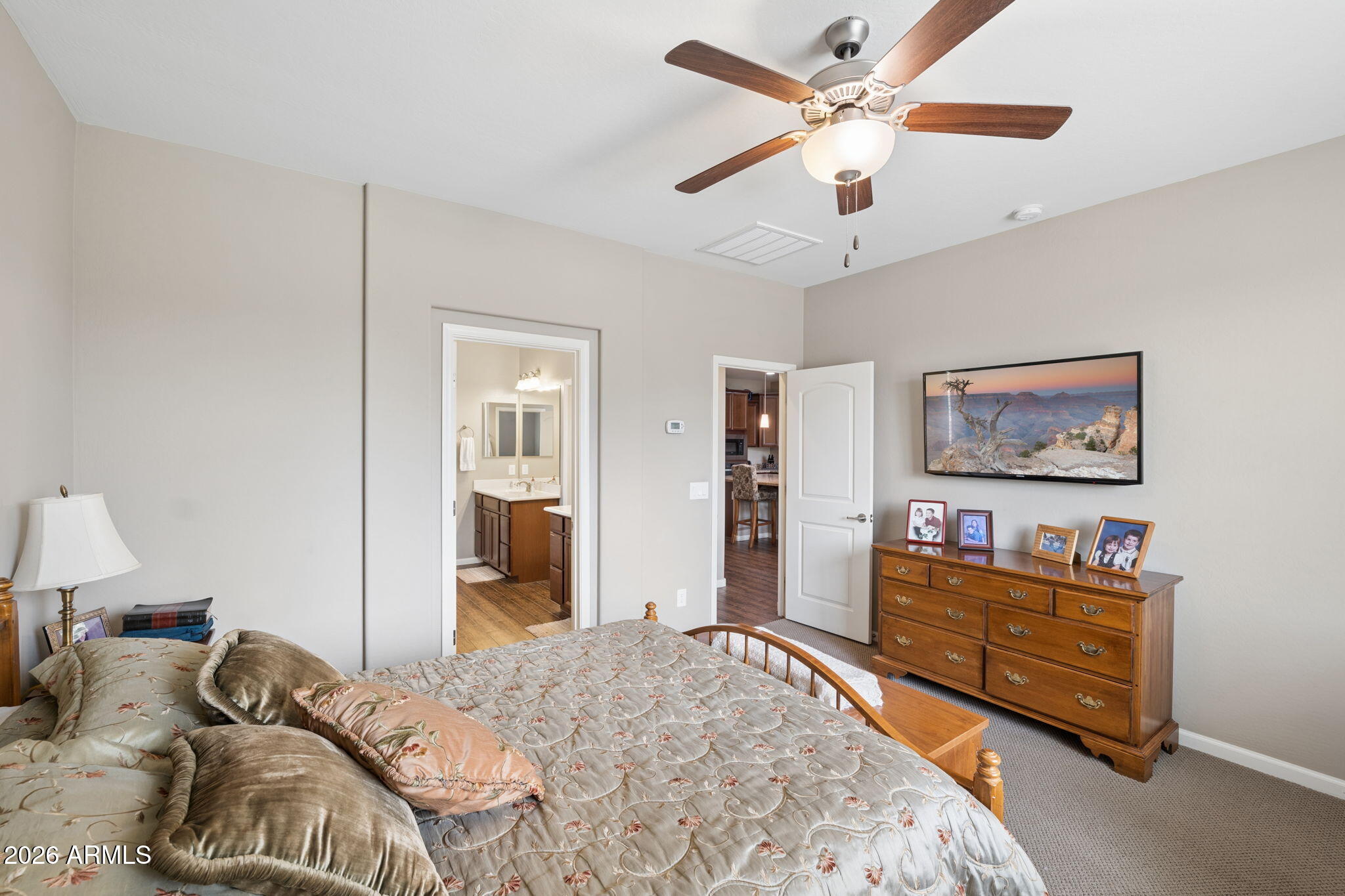 8993 West Ruth Avenue Peoria, AZ 85345 - Photo 10 of 24 a bedroom with a bed and a chandelier