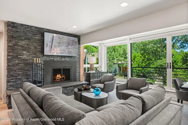 a living room with furniture and a fireplace
