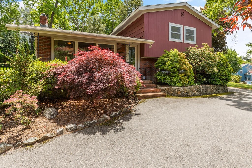 a front view of house with yard and trees