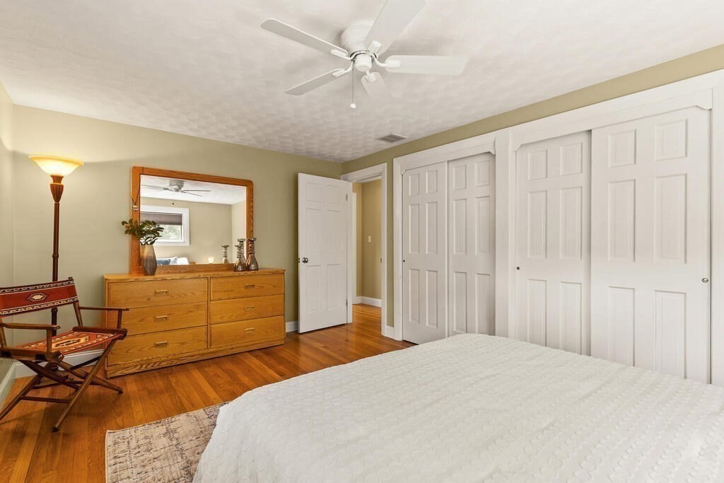 19 West Chardon Road Winchester, MA 01890 - Photo 17 of 40 a bedroom with a bed and a chandelier fan