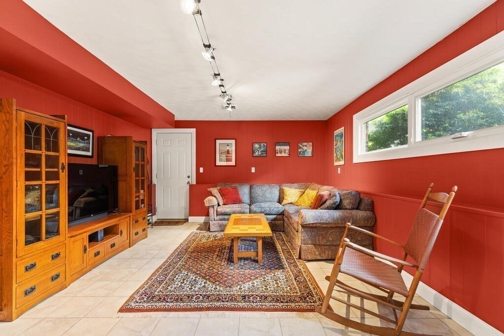 19 West Chardon Road Winchester, MA 01890 - Photo 23 of 40 a living room with furniture a flat screen tv and floor to ceiling window