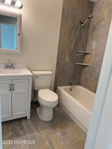 a bathroom with a white toilet sitting next to a bathroom sink and a tub