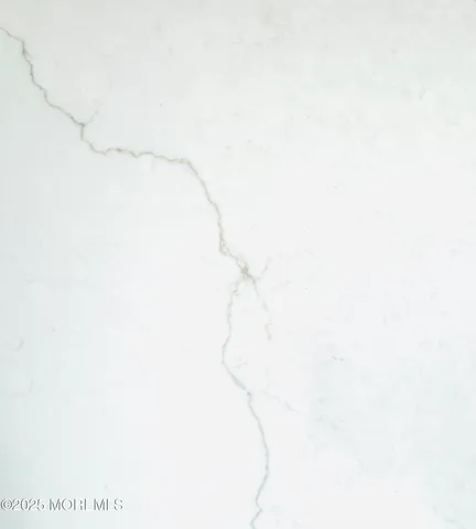 a room with a white wall and a shower