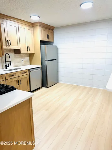 a kitchen with a appliances cabinets and a counter top space