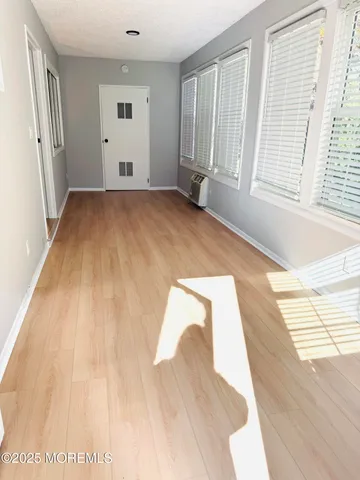 a view of a room with wooden floor and windows