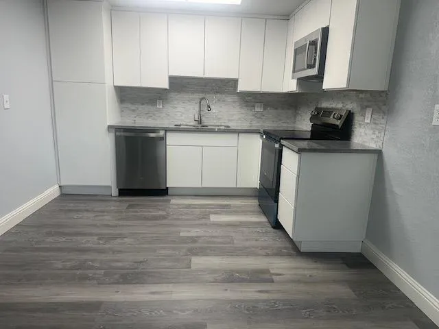 a kitchen with a sink and cabinets