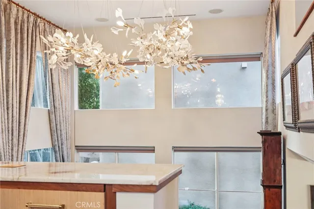 a kitchen with stainless steel appliances kitchen island granite countertop a sink and refrigerator