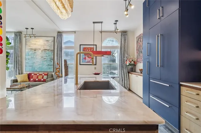 a kitchen with stainless steel appliances granite countertop a sink a stove and a wooden floors