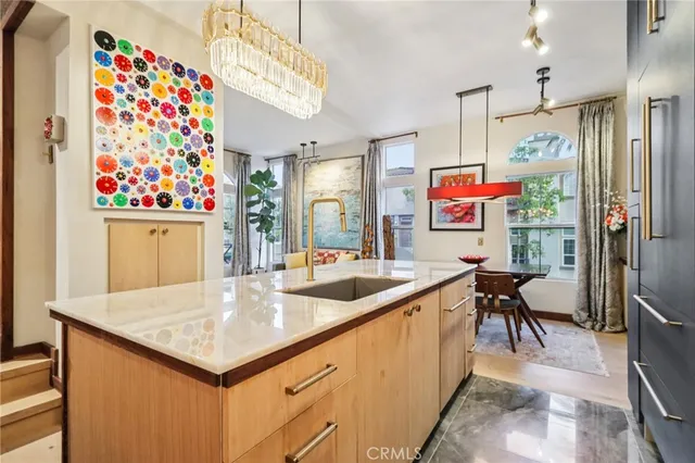 a living room with furniture and a painting on the wall