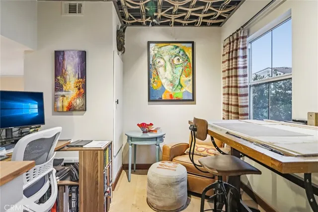 a view of a patio with a table and chairs and potted plants