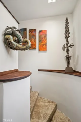 a view of a dining room with a large window and chandelier